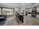 Spacious kitchen with island, breakfast bar, stainless appliances, and a view of the pool at 2541 E Carob Dr, Gilbert, AZ 85298