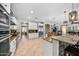Bright kitchen features white cabinets, granite counters, stainless steel appliances, and a large island at 2541 E Carob Dr, Gilbert, AZ 85298