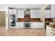 Modern kitchen features stainless steel appliances, granite counters, and custom white cabinets at 2541 E Carob Dr, Gilbert, AZ 85298