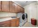 Laundry room featuring sink, cabinets, counter and washer and dryer at 2541 E Carob Dr, Gilbert, AZ 85298