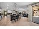 View of open concept living and kitchen area with bar seating and stainless steel appliances at 2541 E Carob Dr, Gilbert, AZ 85298