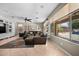Bright living room featuring comfortable seating, modern decor, and a large window showcasing the backyard at 2541 E Carob Dr, Gilbert, AZ 85298