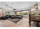 Open living room with a sectional sofa, ceiling fan, and access to outdoor pool area at 2541 E Carob Dr, Gilbert, AZ 85298