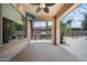 Covered patio area with ceiling fan, outdoor kitchen, and view to the backyard at 2541 E Carob Dr, Gilbert, AZ 85298
