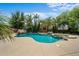 Backyard pool featuring a waterfall and surrounded by lush tropical landscaping at 2541 E Carob Dr, Gilbert, AZ 85298