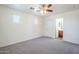 Bright bedroom with plush gray carpet, neutral walls, and two windows at 26505 N Babbling Brook Dr, Phoenix, AZ 85083