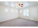 A large bedroom with multiple windows, carpeted floors and ceiling fan at 26505 N Babbling Brook Dr, Phoenix, AZ 85083
