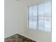 Bedroom with white walls, tile floor, and window with blinds providing natural light at 26505 N Babbling Brook Dr, Phoenix, AZ 85083