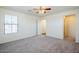A carpeted bedroom with a ceiling fan and one window at 26505 N Babbling Brook Dr, Phoenix, AZ 85083
