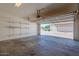 Spacious garage with high ceilings, shelving, and partially open door at 26505 N Babbling Brook Dr, Phoenix, AZ 85083