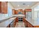 Modern eat-in kitchen with stainless appliances, wood cabinets, tile flooring and island at 26505 N Babbling Brook Dr, Phoenix, AZ 85083