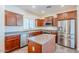 Kitchen features stainless steel appliances, wood cabinets, and center island at 26505 N Babbling Brook Dr, Phoenix, AZ 85083