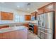 Spacious kitchen features wood cabinets, stainless steel appliances, and center island at 26505 N Babbling Brook Dr, Phoenix, AZ 85083