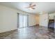 Open floor plan featuring a living area, tile floors, ceiling fan, neutral walls and access to the backyard at 26505 N Babbling Brook Dr, Phoenix, AZ 85083
