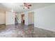 Spacious living room featuring tile floors, neutral paint, ceiling fan and staircase to second floor at 26505 N Babbling Brook Dr, Phoenix, AZ 85083