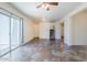 Living area with neutral walls, ceiling fan, tile floors and sliding glass door to backyard patio at 26505 N Babbling Brook Dr, Phoenix, AZ 85083