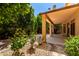 Landscaped backyard with covered patio, stone accents, and lush plants creates a serene outdoor space at 2741 E San Tan St, Chandler, AZ 85225
