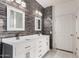 Stylish bathroom features a double sink vanity with decorative gray wood-look tile and modern lighting at 2741 E San Tan St, Chandler, AZ 85225