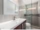 Bathroom featuring a dark wood vanity, white countertops, and a tiled walk-in shower at 2741 E San Tan St, Chandler, AZ 85225