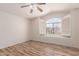Bedroom featuring wood-look floors, a ceiling fan, and a window overlooking neighborhood views at 2741 E San Tan St, Chandler, AZ 85225