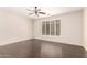 Bedroom with dark hardwood flooring, ceiling fan, and a large window with shutter blinds at 2741 E San Tan St, Chandler, AZ 85225