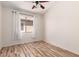 Inviting bedroom with wood-look floors, a ceiling fan, and bright natural light from the window at 2741 E San Tan St, Chandler, AZ 85225