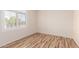 Bright bedroom with wood-look flooring and natural light from the window with plantation shutters at 2741 E San Tan St, Chandler, AZ 85225