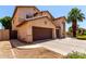 Side view of a two story home with a three car garage and a wooden gate at 2741 E San Tan St, Chandler, AZ 85225