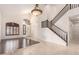 Bright open living room featuring a wood accent floor, staircase, and large entry door at 2741 E San Tan St, Chandler, AZ 85225