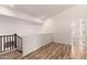 Bright loft space with hardwood floors, white walls and staircase with dark wood railing at 2741 E San Tan St, Chandler, AZ 85225