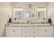 Stylish bathroom showcasing dual sinks, granite countertops, and modern lighting fixtures at 28156 N Edwards Rd, San Tan Valley, AZ 85143
