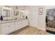 Elegant bathroom featuring double vanity, wood-look floors and a glass-enclosed shower at 28156 N Edwards Rd, San Tan Valley, AZ 85143