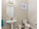 Powder room featuring a pedestal sink, toilet, and decorative fixtures at 28156 N Edwards Rd, San Tan Valley, AZ 85143