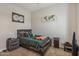 Comfortable bedroom is furnished with a bed, a nightstand, and artwork on the walls at 28156 N Edwards Rd, San Tan Valley, AZ 85143
