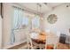 Bright dining room featuring a round table, white chairs, and stylish blue curtains at 28156 N Edwards Rd, San Tan Valley, AZ 85143