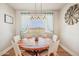 Bright dining room features a round wooden table, white chairs, and a decorative windmill at 28156 N Edwards Rd, San Tan Valley, AZ 85143