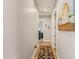 Hallway with wood floors, neutral walls, and decorative wall art at 28156 N Edwards Rd, San Tan Valley, AZ 85143