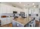 Modern kitchen with white cabinets, stainless steel appliances, and a large island with seating at 28156 N Edwards Rd, San Tan Valley, AZ 85143