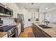 Updated kitchen featuring stainless steel appliances, white cabinetry, and granite countertops at 28156 N Edwards Rd, San Tan Valley, AZ 85143