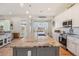 Bright kitchen featuring a granite island, stainless steel appliances, and open access to the backyard at 28156 N Edwards Rd, San Tan Valley, AZ 85143
