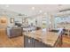 Open concept kitchen with island, granite counters, stainless faucet, and open view to the living room at 28156 N Edwards Rd, San Tan Valley, AZ 85143