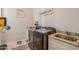 Functional laundry room features stainless steel appliances, a utility sink, and decor at 28156 N Edwards Rd, San Tan Valley, AZ 85143