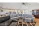 Spacious living room with an open floorplan featuring hardwood floors and a large sectional sofa at 28156 N Edwards Rd, San Tan Valley, AZ 85143