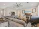 Cozy living room featuring a large sectional sofa, hardwood floors, and neutral colors at 28156 N Edwards Rd, San Tan Valley, AZ 85143