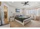 Spacious main bedroom with a ceiling fan, sitting area, and elegant furnishings offers a relaxing retreat at 28156 N Edwards Rd, San Tan Valley, AZ 85143