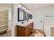 Bathroom with walk-in closet, dual sinks, wood cabinets, and a tile floor at 28806 N 23Rd Ln, Phoenix, AZ 85085