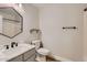 Well-lit half bath with modern fixtures including an undermount sink and tiled floors at 28806 N 23Rd Ln, Phoenix, AZ 85085