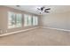 Spacious bedroom featuring three windows with bright, natural light and a ceiling fan at 28806 N 23Rd Ln, Phoenix, AZ 85085