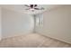 Bright, cozy bedroom with a ceiling fan, plush carpeting, and a shuttered window at 28806 N 23Rd Ln, Phoenix, AZ 85085