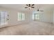Large, open bedroom with white trim, neutral walls, and multiple shuttered windows at 28806 N 23Rd Ln, Phoenix, AZ 85085